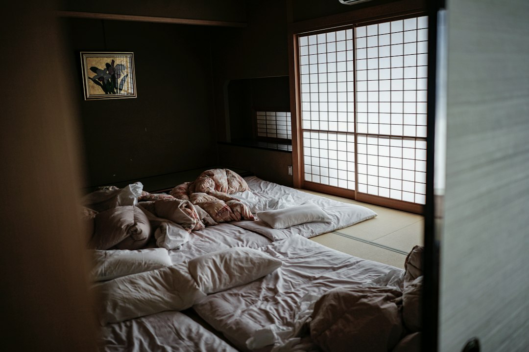 Japanese-style futon bedding laid on tatami flooring as an example of a floor futon setup