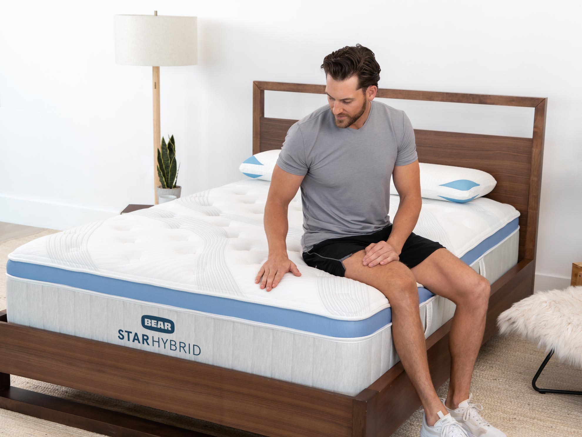 Man feeling the edge support of the Star Hybrid mattress
