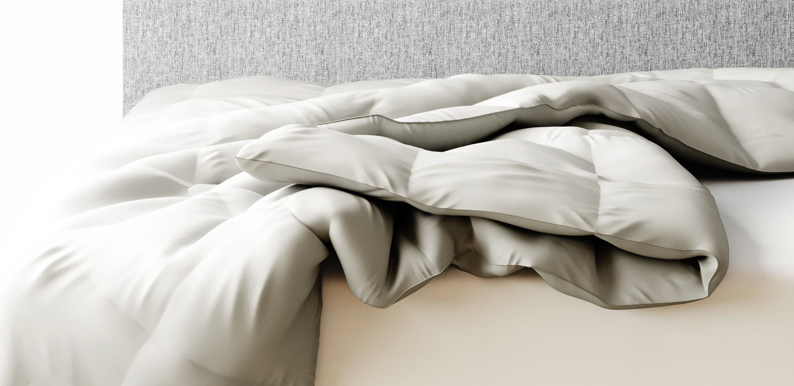 Amerisleep Recover+ Comforter draped on a bed