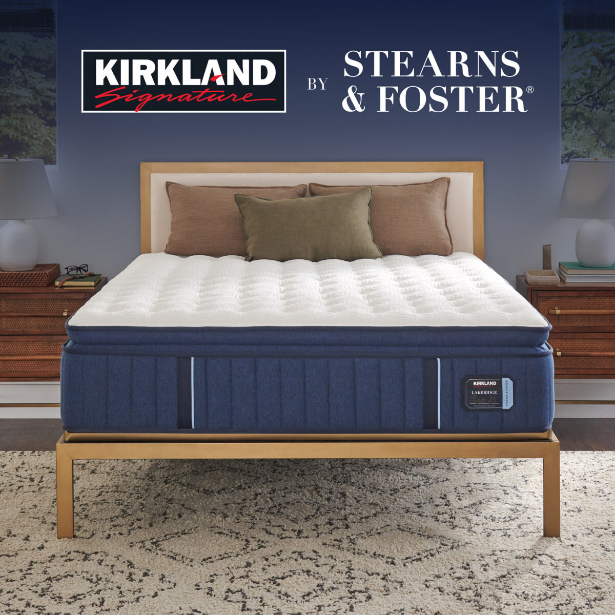 Kirkland Signature Lakeridge Medium Pillow Top mattress displayed in a bedroom, white quilt and navy border