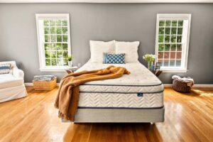 DLX Premier Hybrid mattress in a bright bedroom, official manufacturer photo