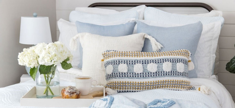 Styled bed with coordinated linens and pillows from HomeGoods inspiration content