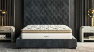 Saatva Solaire adjustable-firmness mattress shown on an upholstered bed