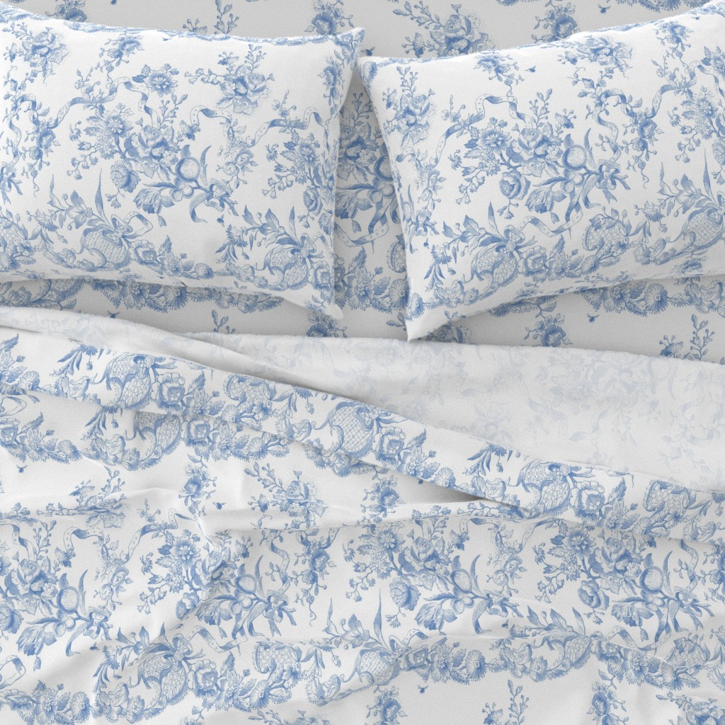 Blue and white rococo patterned Spoonflower sheet set, shown in manufacturer photography
