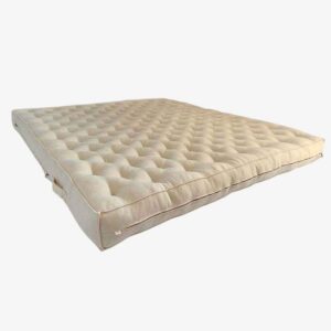 Hand-tufted Woollux wool mattress in a natural fabric cover, angled view, official manufacturer photograph