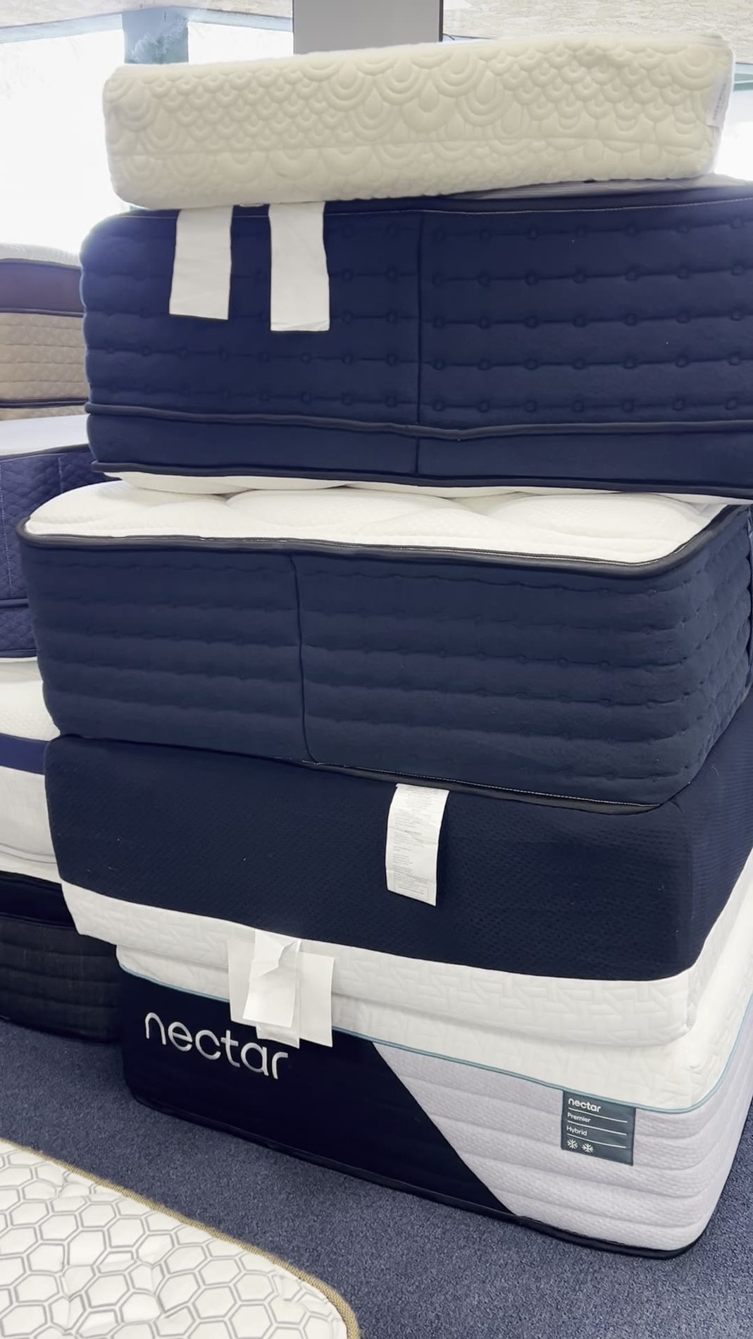 Nectar Premier Hybrid mattress visible in a 2025 Yawnder showroom stack